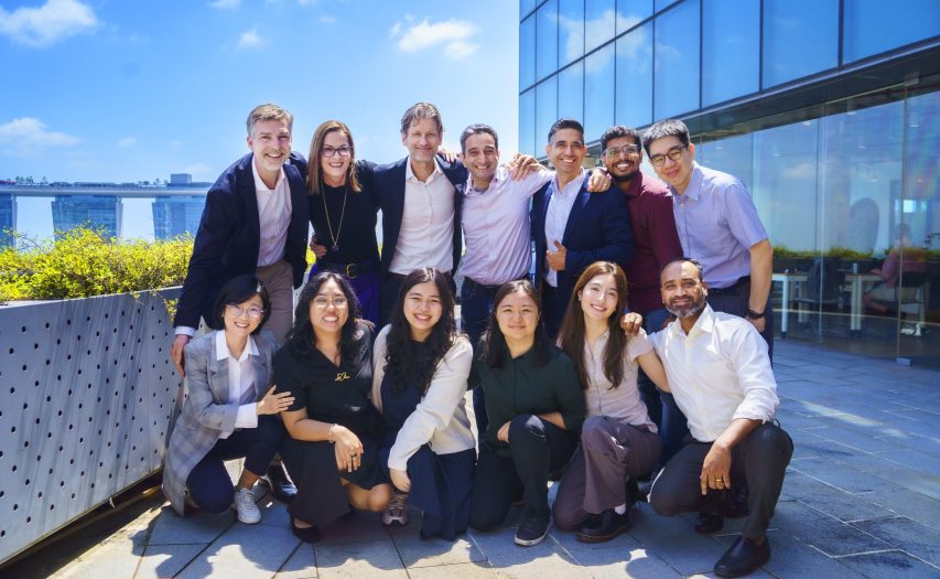 AIQURIS team with Marina Bay Sands Singapore Background